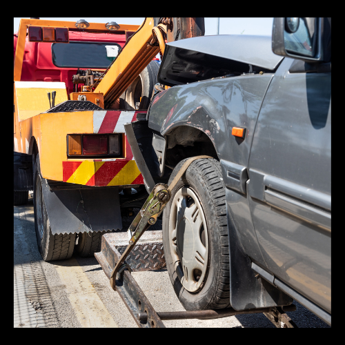 dark gray vehicle being towed